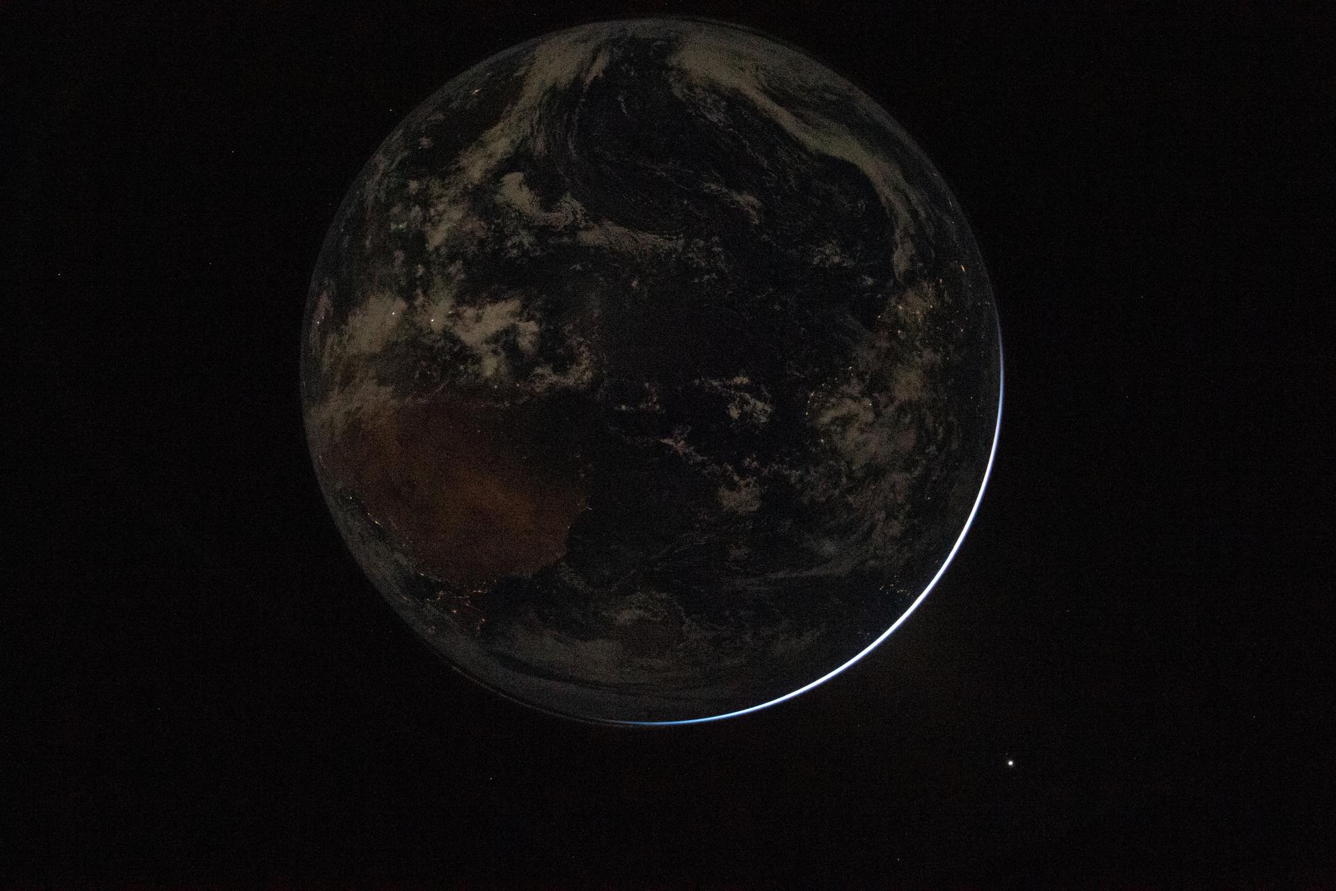 The Earth from space with the words The Global Village